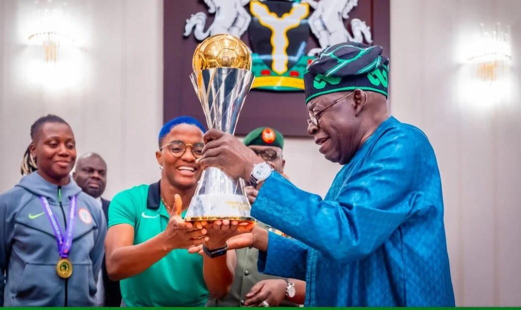 President Tinubu Receives the WAFCON Trophy from the Super Falcons